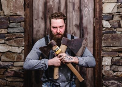 Strong brutal man with a beard and tattoos on his hands